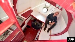 FILE - Jean-Jacques Savin, a former paratrooper, 71, poses aboard his ship made from a barrel on November 15, 2018 at the shipyard in Ares, southwestern France.