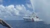 FILE - Chinese Coast Guard members approach Filipino fishermen as they confront each other off Scarborough Shoal in the South China Sea, also called the West Philippine Sea, Sept. 23, 2015.