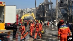Firefighters work the scene of an explosion in Sanhe city in northern China’s Hebei province on March 13, 2024. Rescuers were responding to a suspected gas leak explosion Wednesday in a building in northern China, authorities said. 