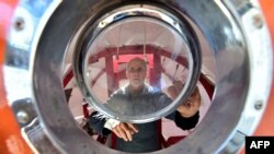 FILE - Jean-Jacques Savin works on the construction of a ship made from a barrel on Nov. 15, 2018, at the shipyard in Ares, France.