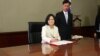 Taiwan's President Tsai Ing-wen signs her first document at her new desk following the inauguration ceremony at the Presidential Office in Taipei, Taiwan May 20, 2016. 
