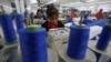 FILE - Laborers work at a garment factory in Hung Yen province, outside Hanoi, Jan. 5, 2017.
