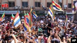 ໃນ​ພາບນີ້​ທີ່​ຖືກ​ເຜີຍ​ແຜ່​ໂດຍ Suwayda24, ສະ​ແດງ​ໃຫ້​ເຫັນ​ປະ​ຊາ​ຊົນ​ຈັດ​ການ​ປະ​ທ້ວງ ໃນ​ຂະ​ນະ​ທີ່​ເຂົາ​ເຈົ້າ​ຍົກ​ທຸງ ດ​ຣູ​ສ໌ ໃນ​ເມືອງ ສ​ເວ​ດາ, ປະ​ເທດ ຊີ​ເຣຍ, 1 ກັນ​ຍາ 2023.
