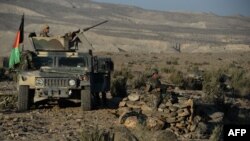 FILE - Afghan security forces take positions following an operation against Islamic State militants in Pachir Wa Agam district of Nangarhar province, Dec. 3, 2016. Local security officials say Afghan forces, backed by U.S. air power, are conducting counterterrorism operations against IS in the Haska Mina district of Nangarhar, where airstrikes occurred Thursday that reportedly killed some civilians. 